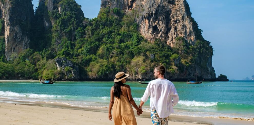 A,Couple,Of,Men,And,Woman,Walking,On,The,Beach